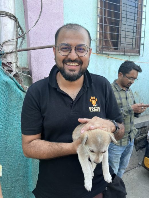 Dr Balaji Chandrashekar, Director of Vet 24-7 India, holding a puppy during a Mission Rabies drive